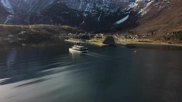 Electric passenger catamaran Vision of the fjords is approaching Flam harbor in beautiful winter sun