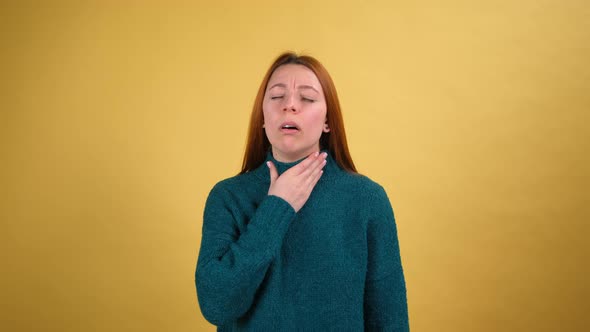 Young Red Hair Woman in Green Sweater Posing Isolated on Yellow Color Background Studio