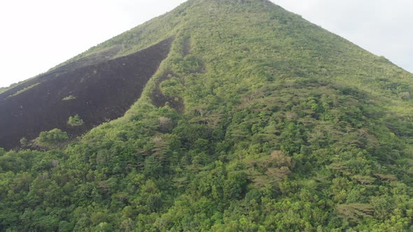 Aerial: flying over Banda Islands active volcano Gunung Api lava flow Indonesia 