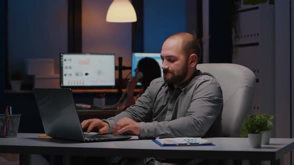 Happy Successful Businessman Enjoying While Looking at Laptop Computer