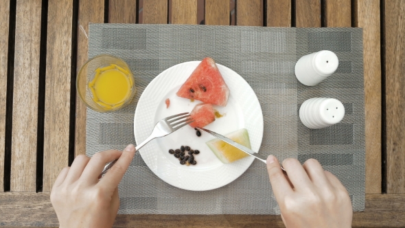 Lady Is Using Utensils To Cut Meal In Small Bites