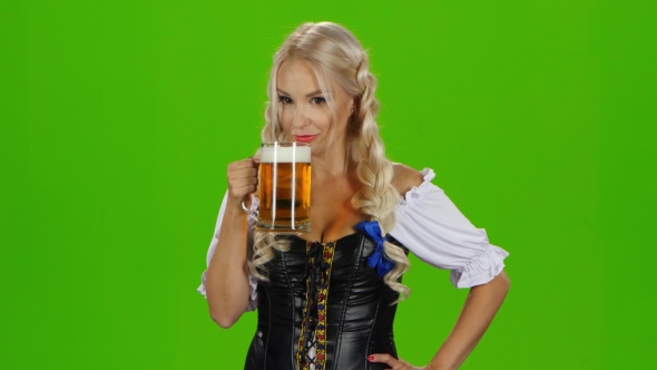 Women In Traditional Bavarian Tracht Drinking Beer And Showing Thumbs Up. Green Screen