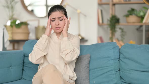 Indian Woman with Headache on Sofa 