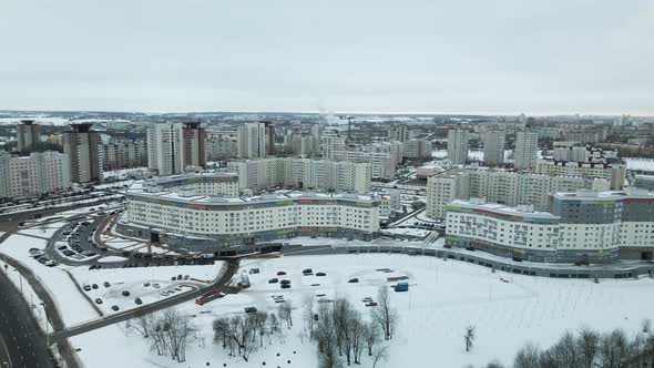 Suburb of a big city. City block from the height of the flight. City highway with busy traffic.