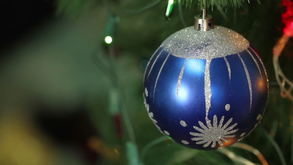 Blue Ball With Garland On a Christmas Tree