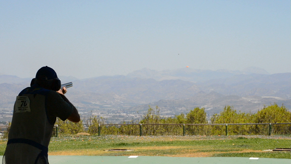 Shooter Man Aiming and Firing a Rifle