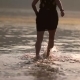 Girl Runs Along The Beach Knees In Water - VideoHive Item for Sale