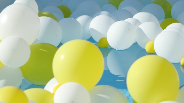 Yellow And White Balloons Floating On The Water