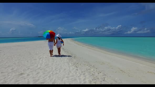 Guy and girl engaged on exotic bay beach break by blue ocean and white sand background of the Maldiv