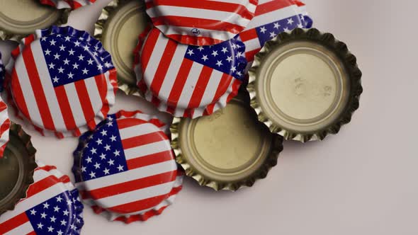 Rotating shot of bottle caps with the American flag printed on them 