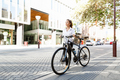 Portrait of happy young female bicyclist - PhotoDune Item for Sale