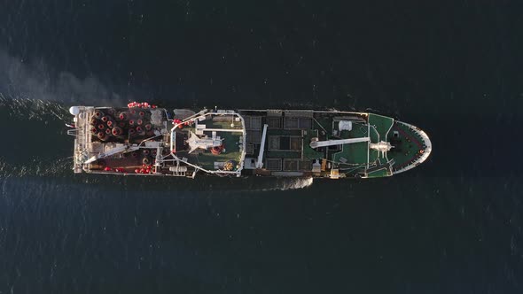 View From the Drone Vertically Down on a Fishing Trawler at Sea on the Move