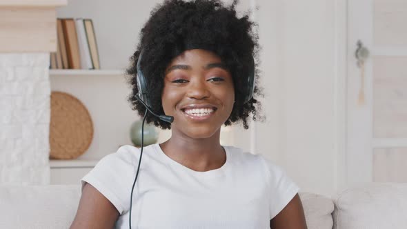 Smiling African Young Woman Wears Headset Talks to Web Camera Making Distance Online Video