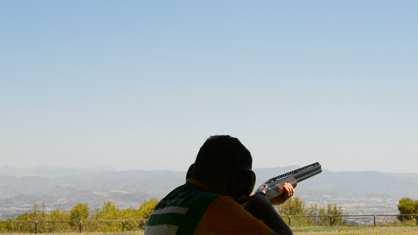 Shooter Aiming and Firing a Rifle