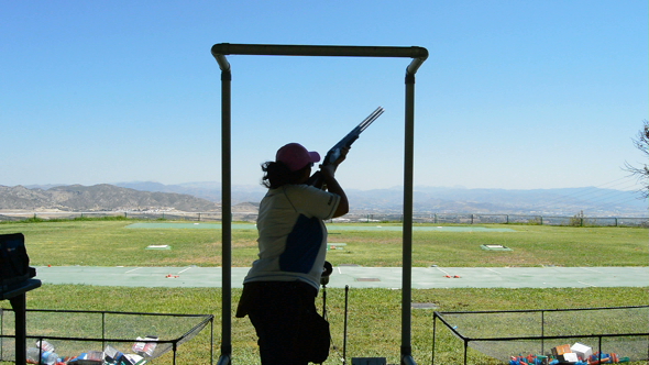 Shooter Woman Aiming and Firing in Skeet