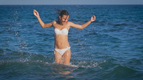 A Young Beautiful Woman Jumping in the Sea