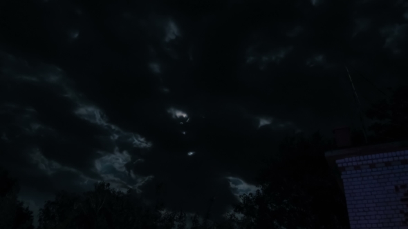 Night Moon Rising On The Horizon Over The Trees And Clouds. 