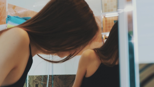 Young Brunette Girl Brush Teeth In Front Of Mirror In Bathroom. Sink. Smile