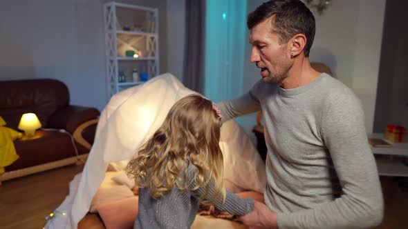 Handsome Father Spinning Cute Little Daughter Dancing in Living Room at Home