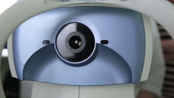 Modern Automated Medical Machine Examining Eyeball. Eye Examination Test On a Professional Medical