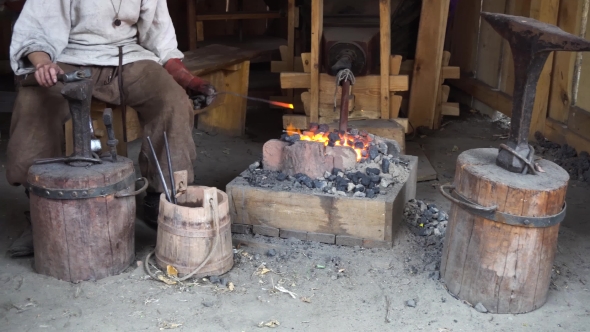 Blacksmith Working At Smithy