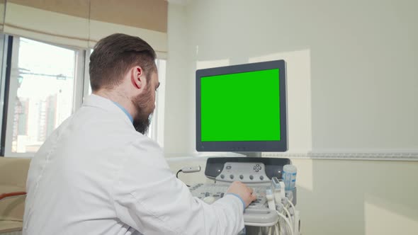 Doctor Operating Ultrasound Scanner with Green Screen