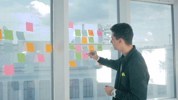 Young Handsome Man Writing On Sticky Notes