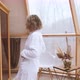 A Young Woman in a White Bathrobe Enjoys Spa Treatments in the Sauna - VideoHive Item for Sale