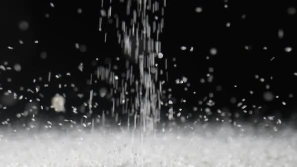 Particles of White Dry Sand Pour in Stream Hit the Surface and Scatter in Different Directions on an