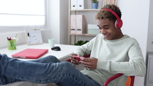 Addicted Teenage Man Playing Video Games on Phone App and Celebrating Victory