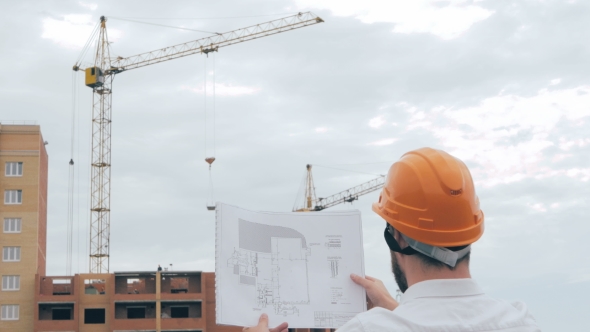 Chief Architect At Construction Site. Chief Architect In a Hard Hat At Construction Site