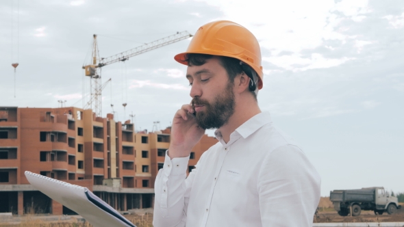 Architect Talking On Cell Phone On a Construction Site.