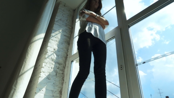 Young Girl Walking On Windowsill