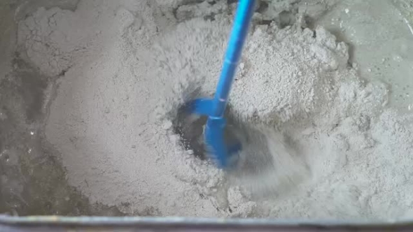 Mixing Of a Plaster Solution By An Electric Drill.
