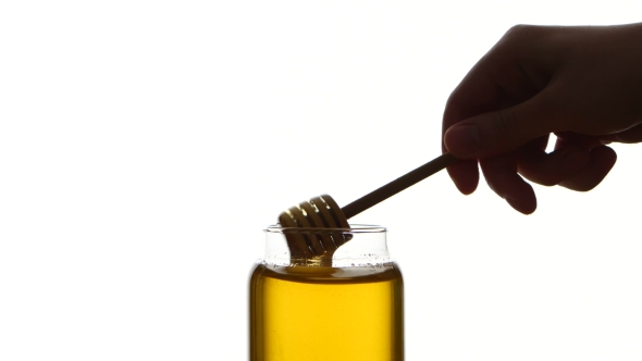 Glass Jar Of Honey With Wooden Drizzler, Pick It Up, Isolated On White