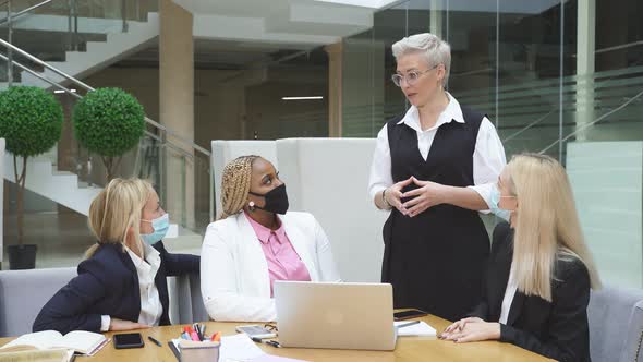 Group of Interracial Business Women Listening To Adult Female Boss Successful Cooperation of