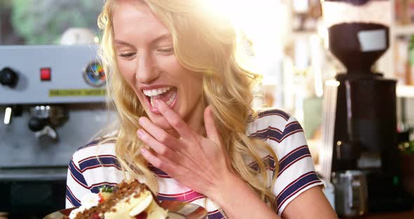 Woman holding a plate of desserts