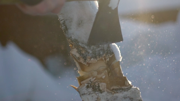 An Unknown Man Chops Wood In The Winter. Lumberjack Chopping Wood