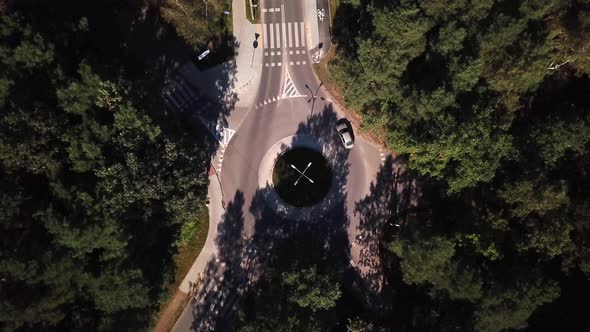 Small roundabout aerial shot. Road in the forest.4k Cars driving