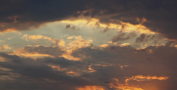 Plane In Flight At Sunset