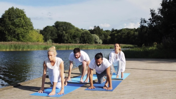 Group Of People Making Yoga Exercises Outdoors 1