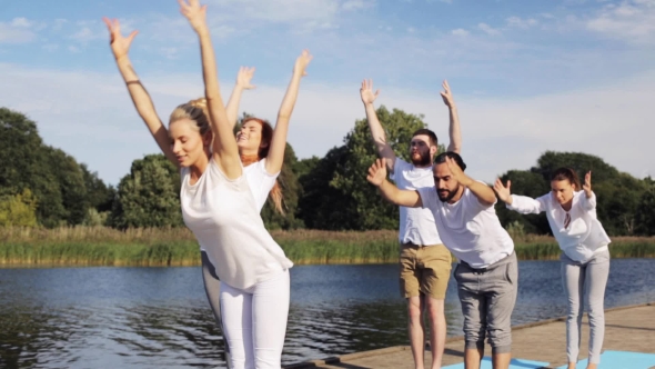 Group Of People Making Yoga Exercises Outdoors 3