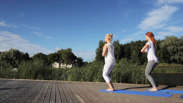 Group Of People Making Yoga Exercises Outdoors 13