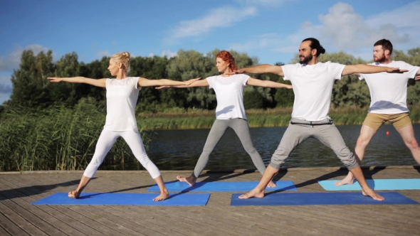 Group Of People Making Yoga Exercises Outdoors 23