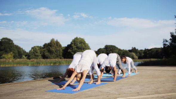 Group Of People Making Yoga Exercises Outdoors 68