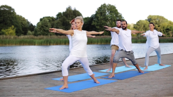 Group Of People Making Yoga Exercises Outdoors 73