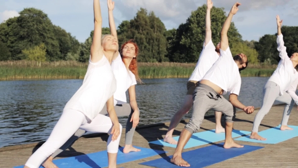 Group Of People Making Yoga Exercises Outdoors 81