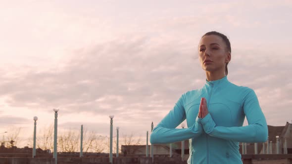 Young, beautiful and sporty woman having evening training outdoor.