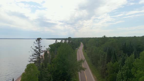 Aerial view drone shot of a pretty scenic drive in Madeline island, freeway with a view