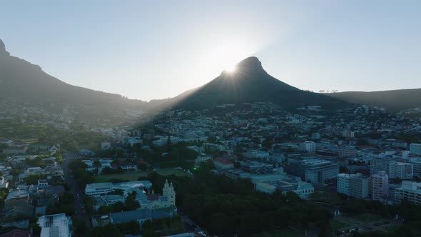 Slide and Pan Shot of Pointed Summit of Lions Head Mountain Towering Above Town and Casting Shadow